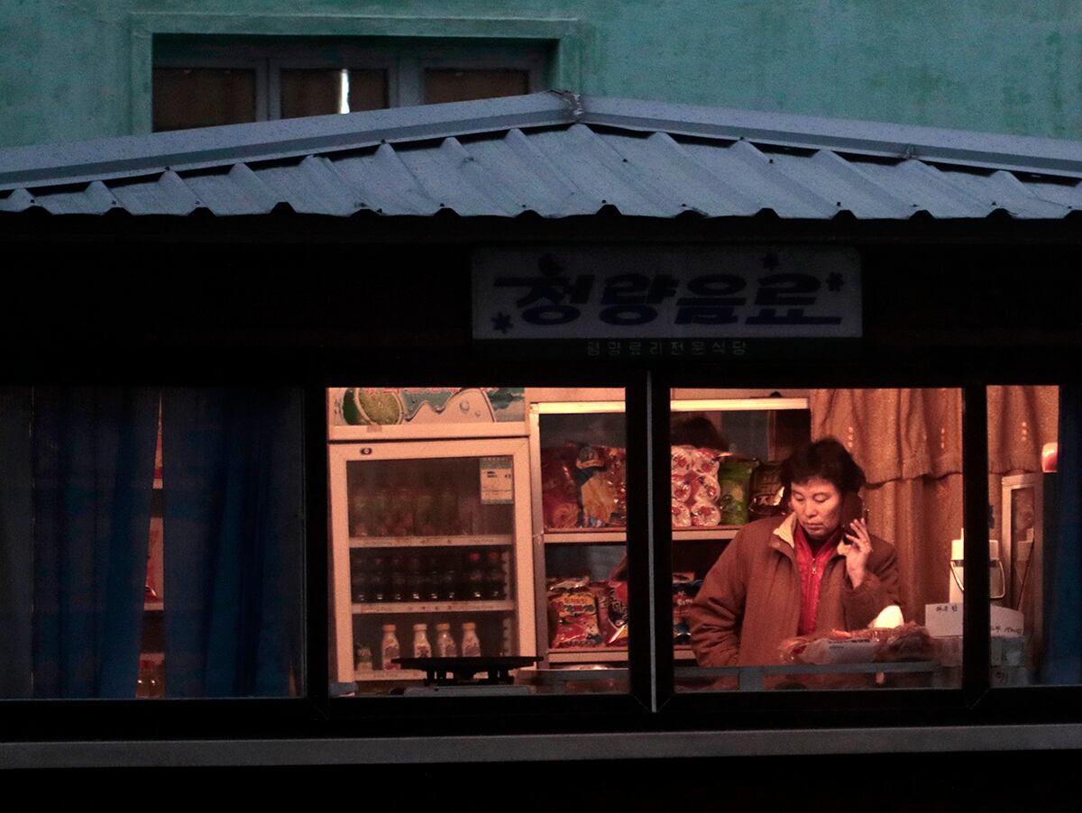 사진은 평양의 한 가판대에서 휴대폰을 사용하는 모습.