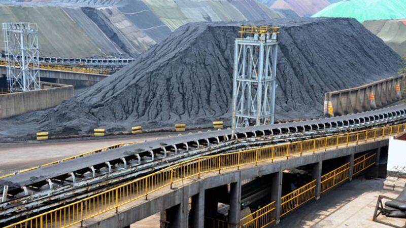 Piles of imported coal are seen at a coal terminal of a port in Lianyungang, eastern-central China's Jiangsu province, July 26, 2018. 