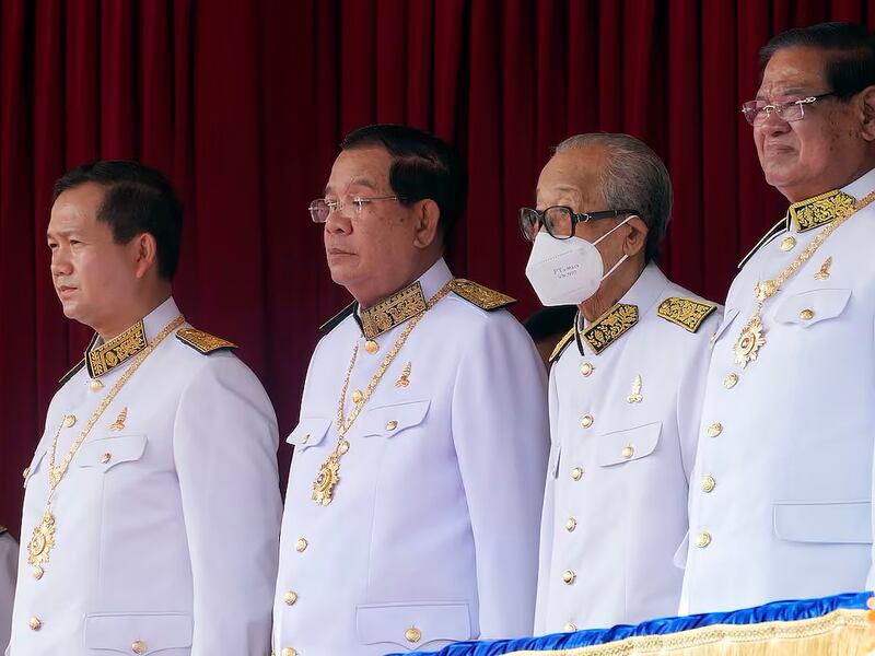 Cambodian Prime Minister Hun Manet, far left, stands next to his father Hun Sen,  former prime minister, left,  during the country's 70th Independence Day in Phnom Penh, Nov. 9, 2023.