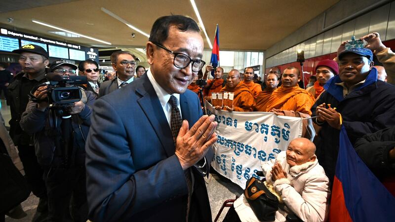 Leader of the Cambodia National Rescue Party (CNRP) Sam Rainsy salutes supporters at the Roissy-Charles de Gaulle airport, north of Paris, Nov. 7, 2019.