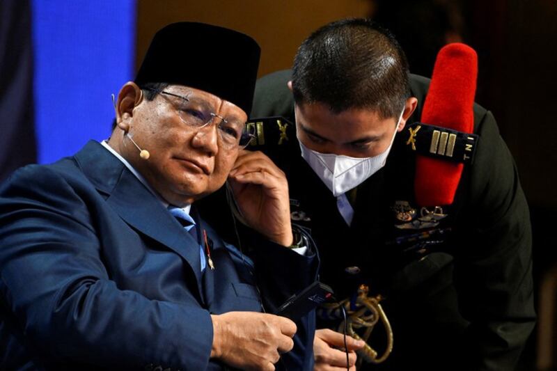 Indonesian Defense Minister Prabowo Subianto speaks with an aide during the second plenary session of the 19th Shangri-La Dialogue in Singapore, June 11, 2022. Credit: Reuters