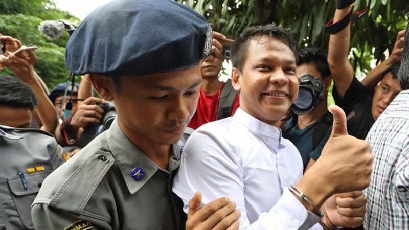 Phyo Wai Win, a reporter at Myanmar's Eleven Media Group, arrives at Insein Prison after appearing at a courthouse in Yangon's Tamwe township, Oct. 10, 2018.