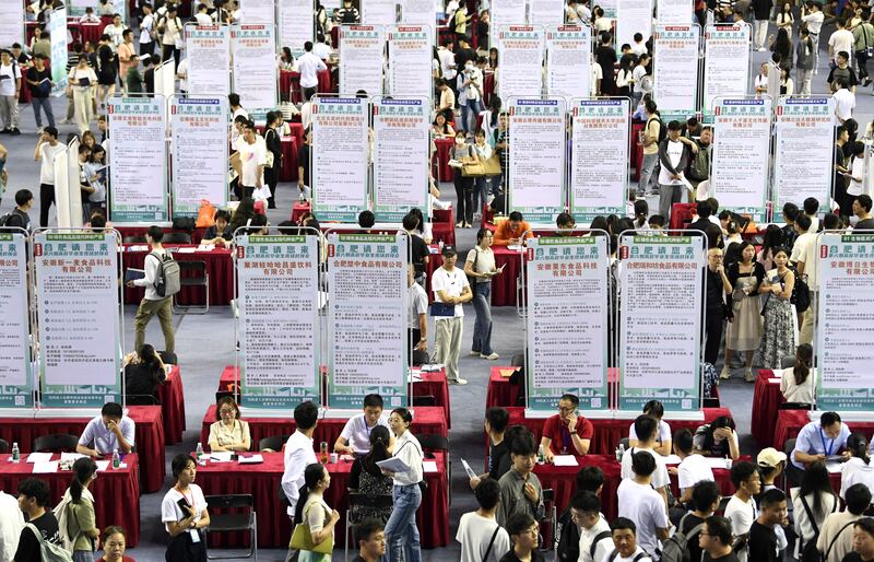 People attend a job fair for university graduates in Hefei, China Sept. 4, 2023.