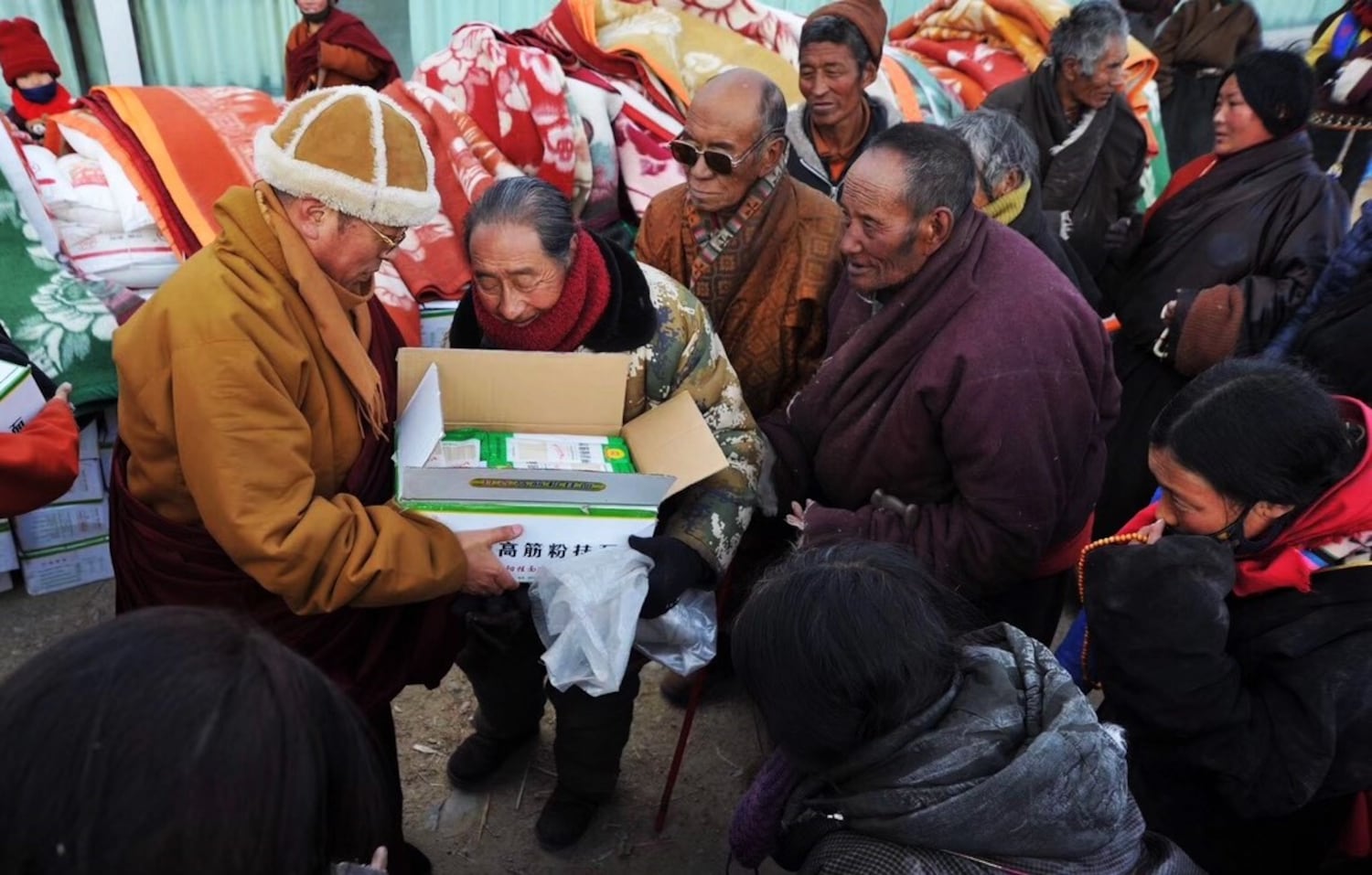Tibetan Buddhist leader and philanthropist Tulku Hungkar Dorje is seen here, in an undated photo, distributing clothes and blankets to Tibetan people. (Citizen photo)