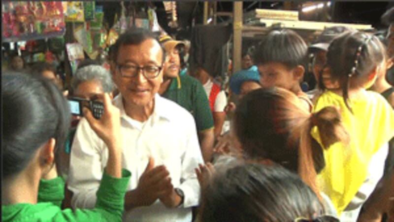 Sam Rainsy greeting the people on polling day, July 28, 2013.