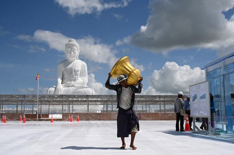 Workers prepare the area around the marble Maravijaya Buddha statue in Naypyidaw on July 21, 2023, ahead of its opening on August 2. Credit: AFP