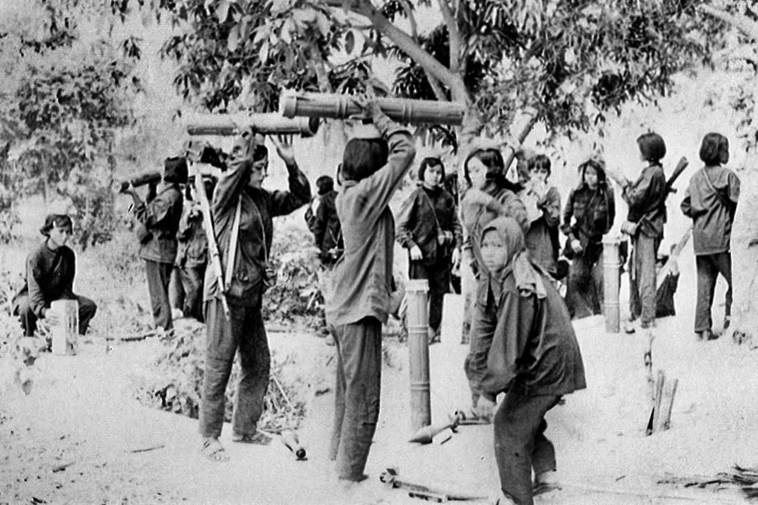 Women in the Khmer Rouge military prepare to carry rocket launchers and other weapons in this undated photo.