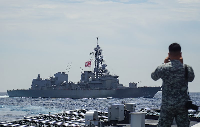 A member of the Philippine Navy looks out at the Japan Maritime Self-Defense Force's destroyer Takanami during a joint maritime exercise in the South China Sea on June 14, 2025.