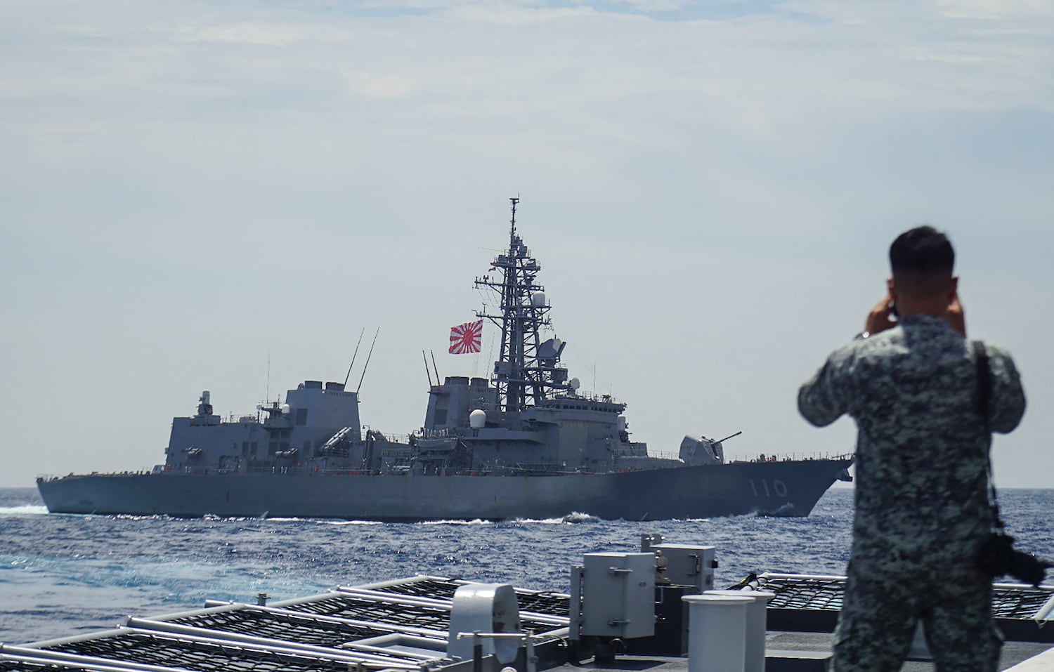 A member of the Philippine Navy looks out at the Japan Maritime Self-Defense Force's destroyer Takanami during a joint maritime exercise in the South China Sea on June 14, 2025.
