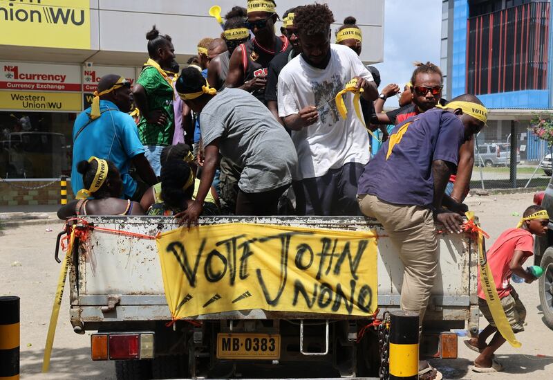 Supporters of a Honiara city council candidate exit a truck during a campaign rally, April 14, 2024. (Stephen Wright/BenarNews)