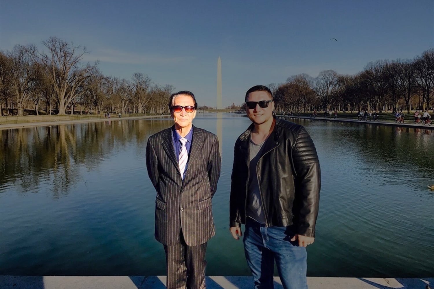 Qurban Mamut, left, stands with his son, Radio Free Asia journalist Bahram Sintash, in front of the Washington Monument in Washington D.C., 2017.