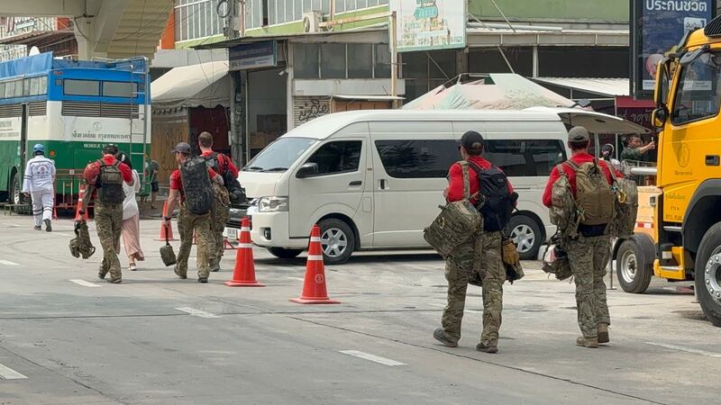 Rescuers from the U.S. Indo-Pacific Command walk to the building collapse site in Bangkok, March 31, 2025. (Phetsiam Promngoy/RFA Lao