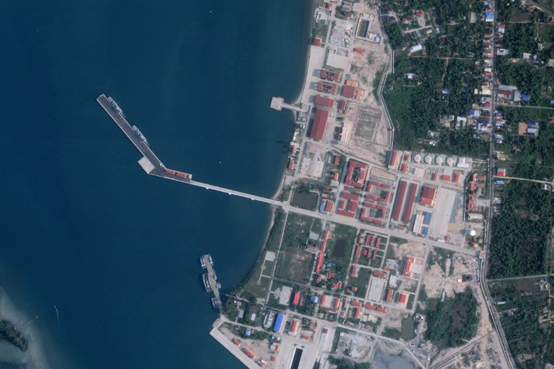 This handout satellite photo obtained from Planet Labs PBC and taken on March 19, 2025 shows two military ships berthed at a pier (C) at Cambodia's Ream naval base.