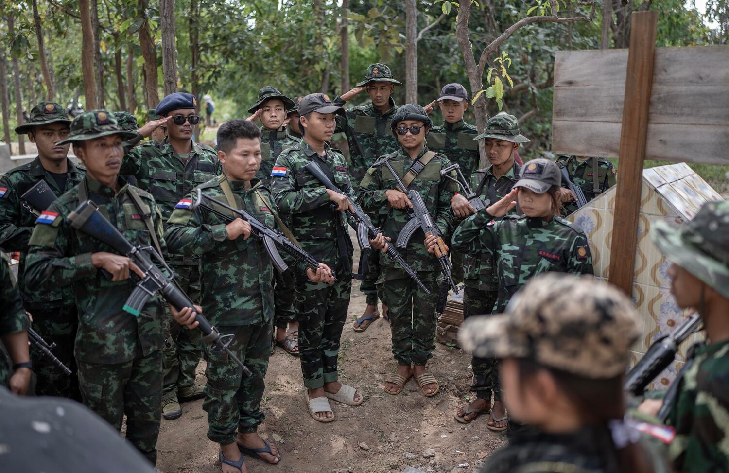 Karenni Nationalities Defense Force fighters gather at a martyrs cemetery to commemorate the fighters who died fighting Myanmar's military in Demoso, Kayah state, Nov. 2, 2024. Mothers wept, fighters stood in-line and saluted as others sang songs, lit candles and prayed over their graves. (RFA)