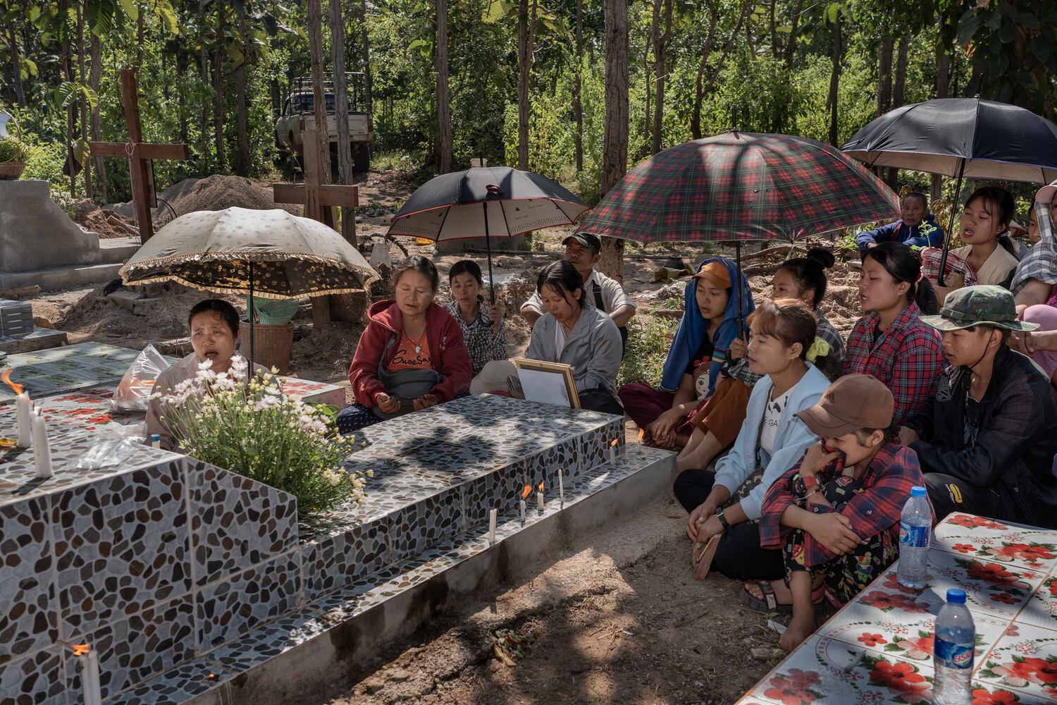 People pray at a grave commemorating a fighter who died fighting Myanmar's military in Demoso, Kayah state, Myanmar, Nov. 2, 2024. (RFA)