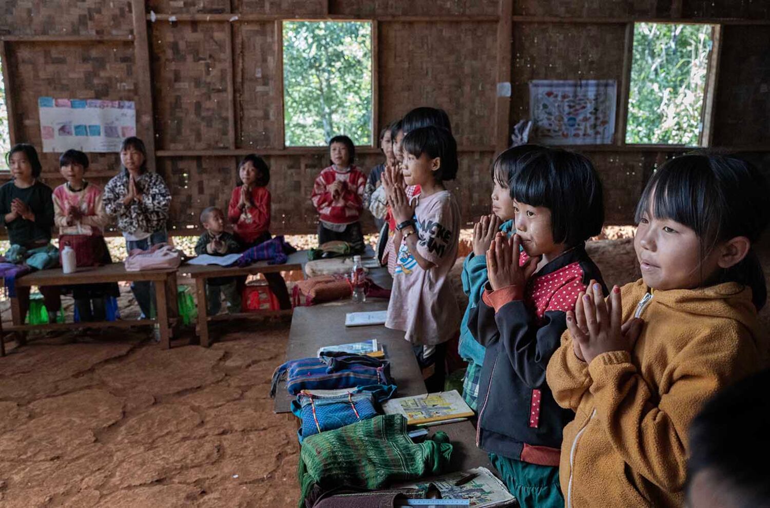 Internally displaced children greet a visitor at a newly built school in southern Shan state, Myanmar, Nov. 4, 2024.