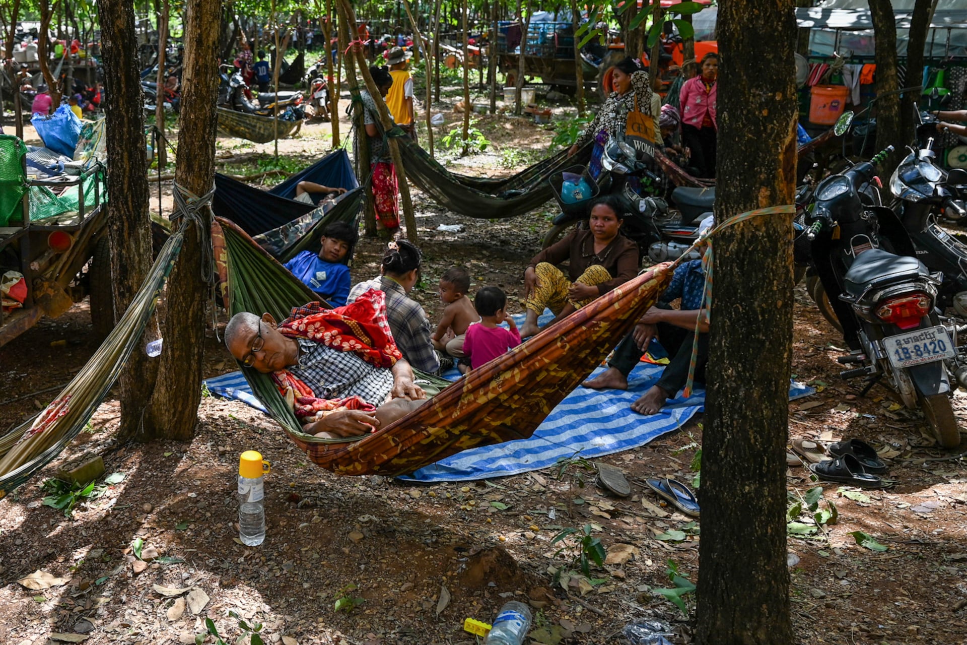 People who fled their homes near the Cambodia-Thailand border rest on the grounds of a pagoda in Oddar Meanchey province on July 25, 2025.