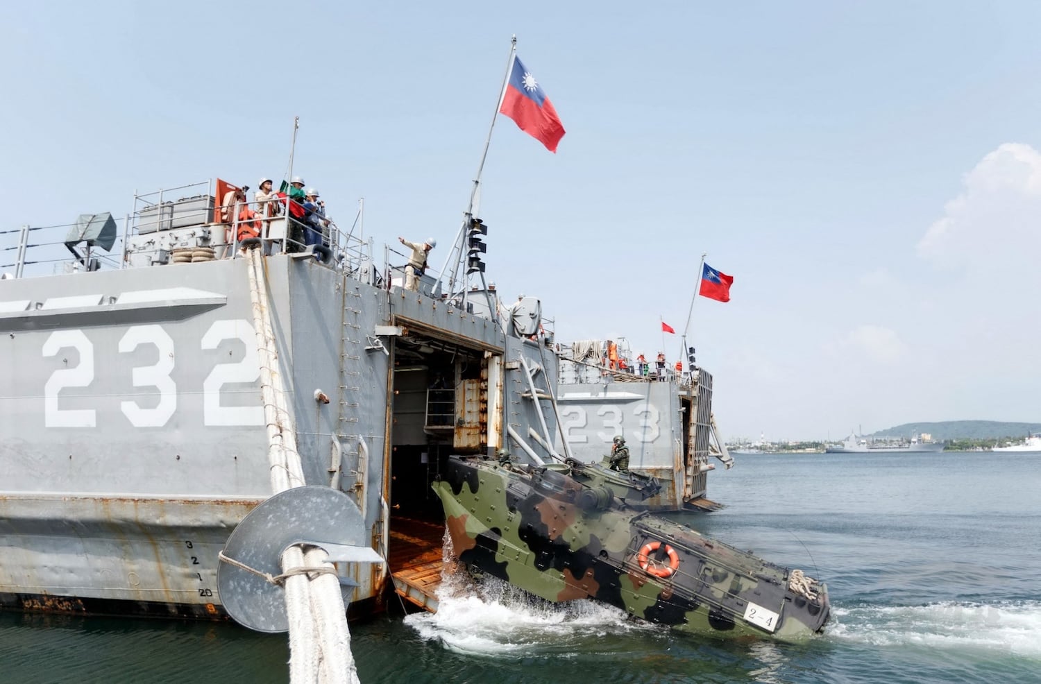 This photograph released by Taiwan's Military News Agency shows soldiers driving a personnel vehicle into a warship near Taiwan during the annual Han Kuang drill on Aug. 22, 2016.