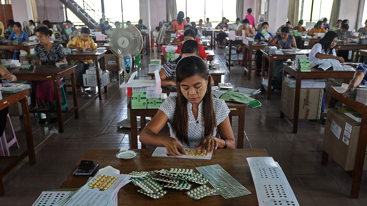 Myanmar workers pack medicine pills delivered into the country by the U.S. Agency for International Development (USAID) at a warehouse in Yangon on March 7, 2013.