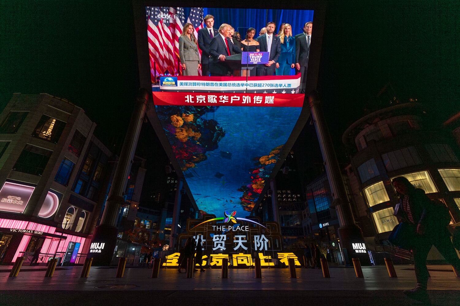 The evening news on Chinese state media reports on Republican presidential nominee Donald Trump on an outdoor screen in Beijing, Nov. 6, 2024.
