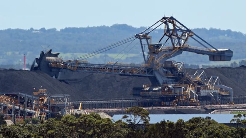 A machine moves coal for export at the Port of Newcastle in the city of Newcastle, New South Wales, Australia, Nov. 18, 2015.