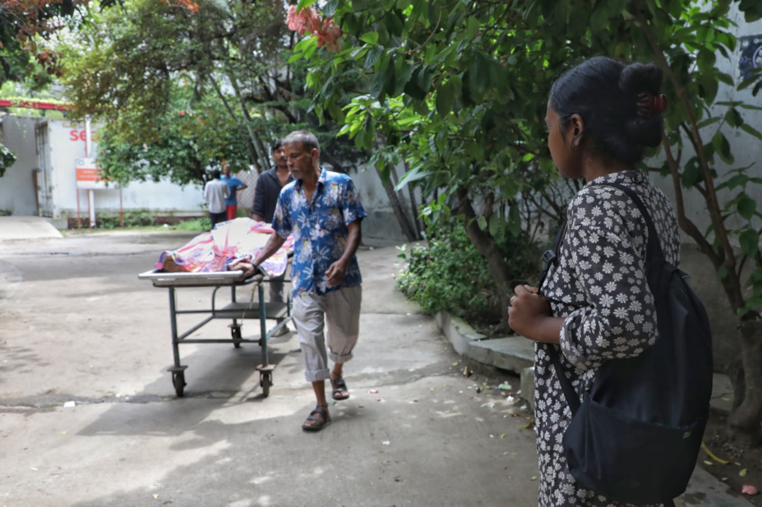 Sanjida Akter, right, waits in front of the mortuary of the Dhaka Medical College and Hospital to receive the body of her brother who was killed during a clash in Dhaka three days earlier, July 22, 2024. (Jibon Ahmed/BenarNews)