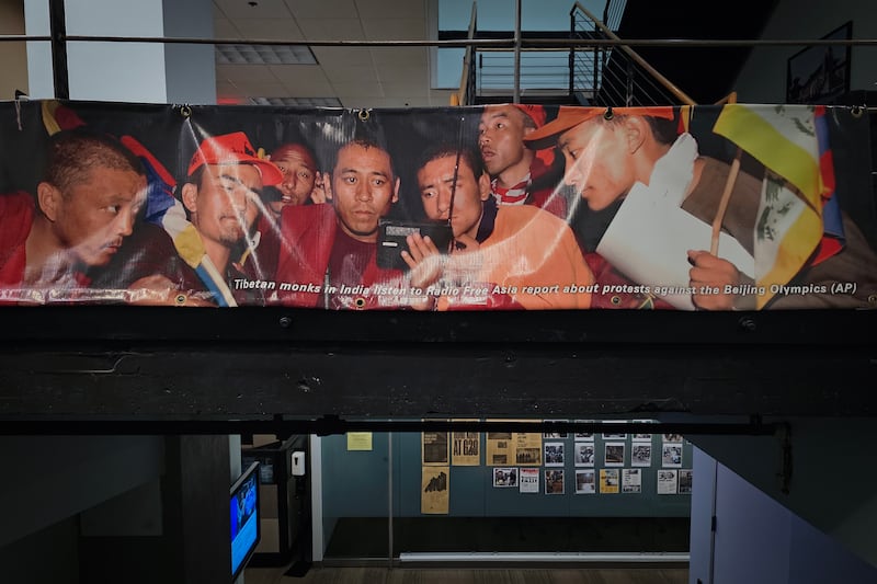 A banner showing Tibetan monks listening to the radio is seen at RFA headquarters in Washington, March 24, 2025.