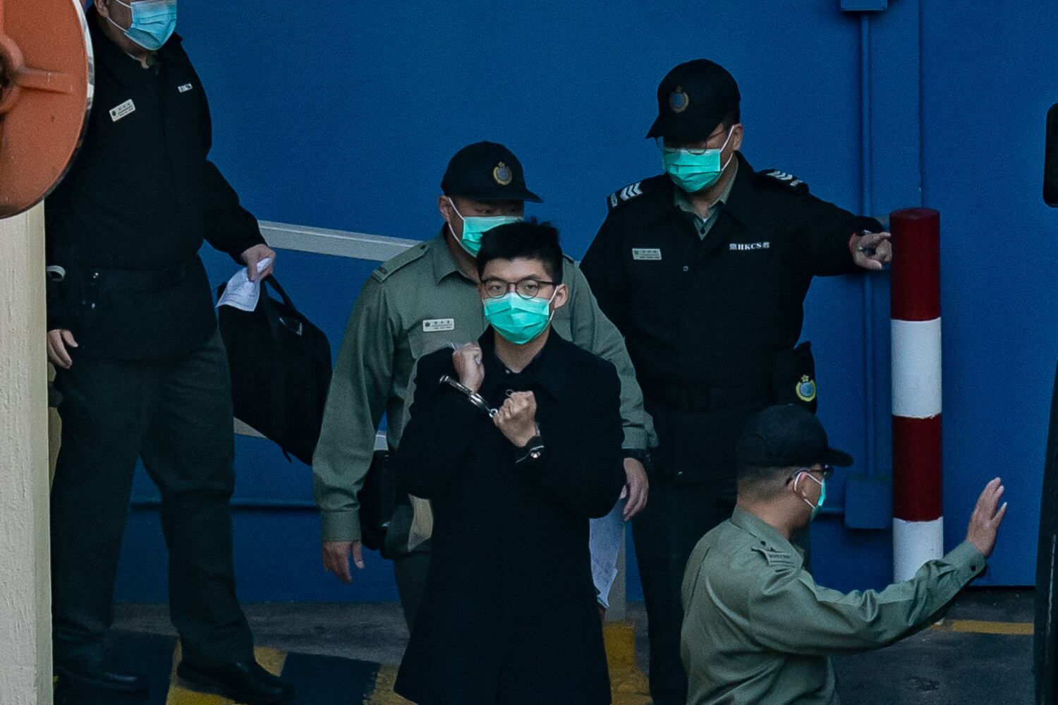 Pro-democracy activist Joshua Wong prepares to board a Correctional Service Department van at Lai Chi Kok ahead of a court hearing at Lai Chi Kok Reception Centre on December 18, 2020 in Hong Kong. (Anthony Kwan/Getty Images)