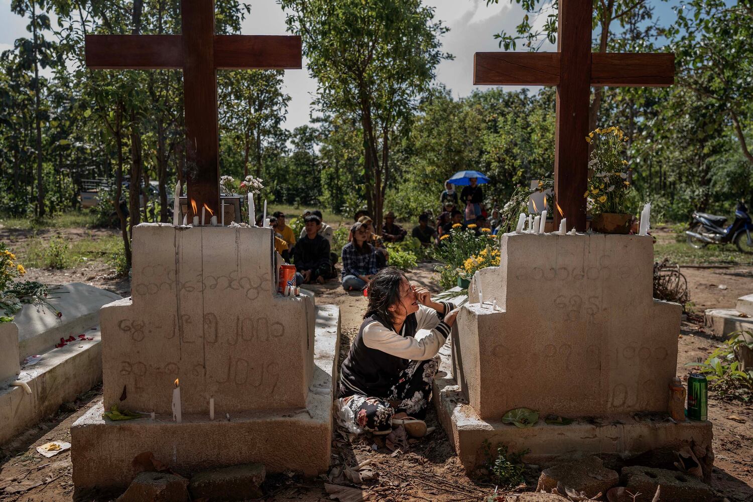 Katarina, 48, grieves her 24-year-old son Thomas’s death at a martyrs cemetery during an event commemorating the fighters who died fighting Myanmar military in Demoso, Kayah state, Nov. 2, 2024. Thomas died in an airstrike. (RFA)