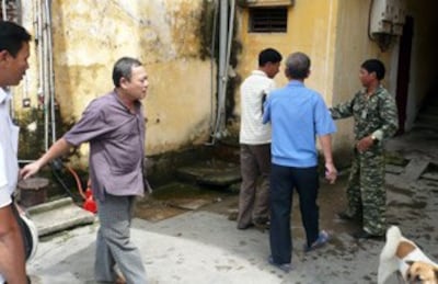 Công an phường Lê Hồng Phong (mặc đồ rằn ri, bên phải) ngăn cản các tín đồ Tin Lành nhóm lại cầu nguyện. RFA PHOTO.