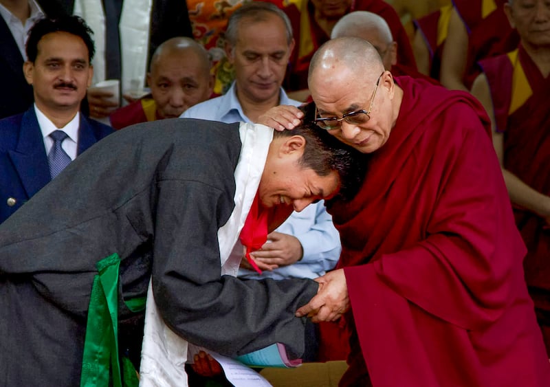 Lobsang Sangay, left, the new elected leader of Tibet's government in exile, is greeted by the Dalai Lama during his swearing-in ceremony in Dharmsala, India, Aug. 8, 2011.