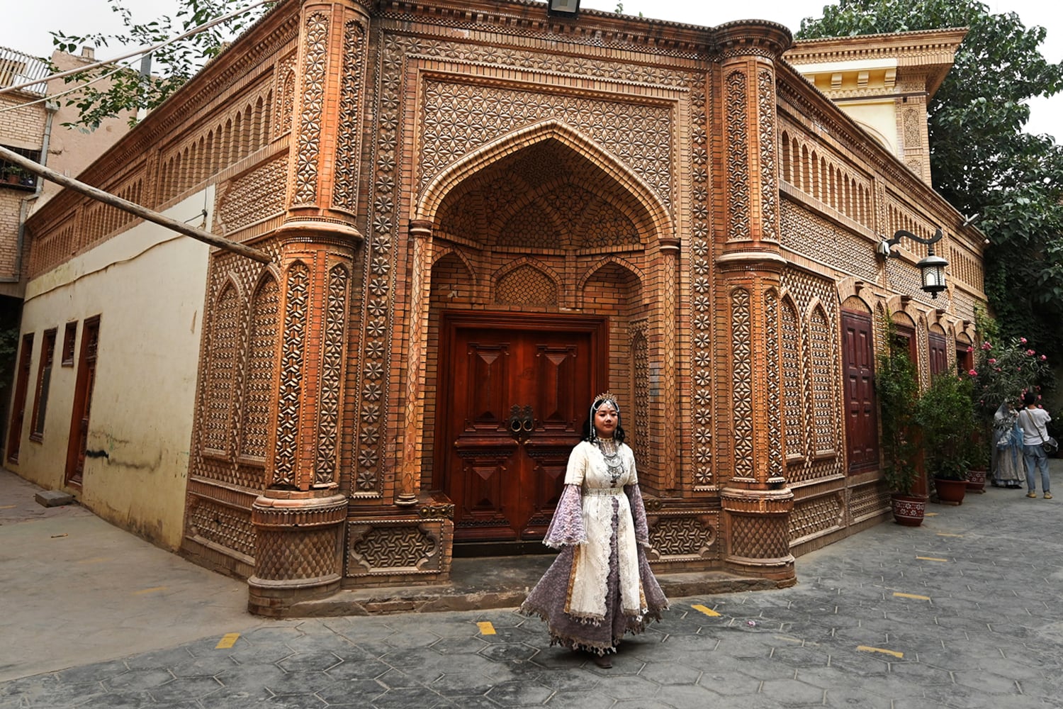 A Uyghur woman wears traditional clothing in Kashgar's old town in northwestern China's Xinjiang region, July 20, 2023.