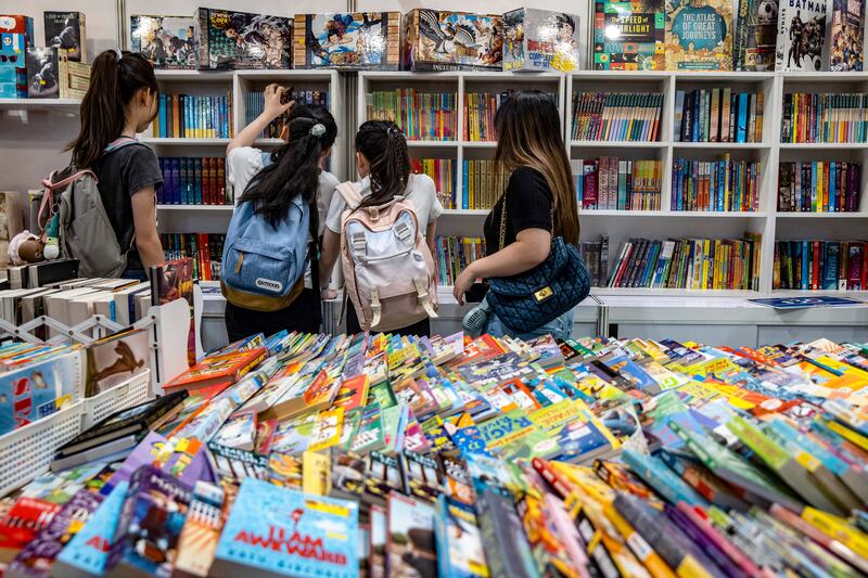 People attend an annual book fair at the Hong Kong Convention and Exhibition Centre (HKCEC) in Hong Kong on July 17, 2024. (Photo by Isaac LAWRENCE / AFP)
