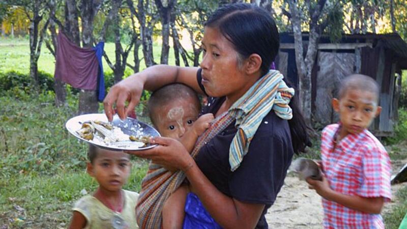 A Myanmar woman and children displaced by fighting between government troops and the Arakan Army take shelter at a displacement camp in Kyauktaw township, western Myanmar's Rakhine state, Dec. 23, 2018.