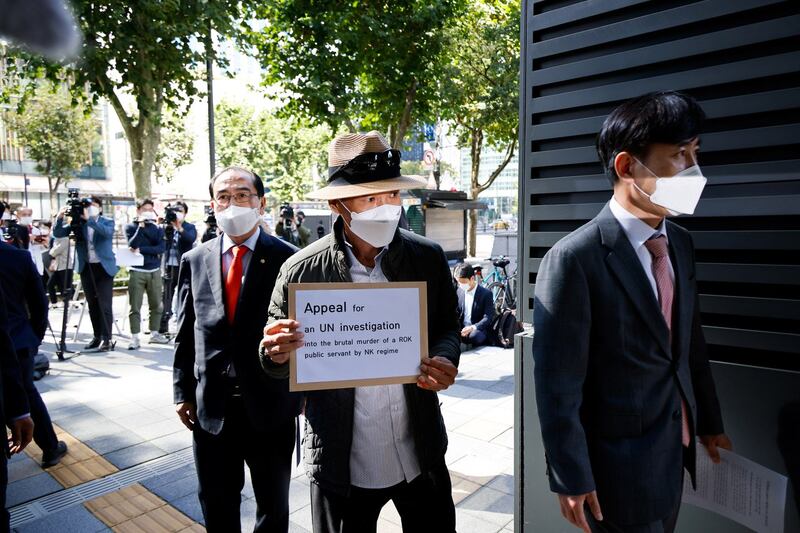 Lee Rae-jin, the older brother of a South Korean fisheries official shot dead by the North Korean military, and lawmakers get into the Office of the United Nations High Commissioner for Human Rights, with a document to appeal for a U.N. investigation on his brother's death, in Seoul, South Korea, October 6, 2020. 