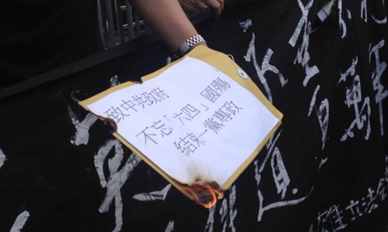 2015年4月5日，遊行人士在中聯辦門外焚燒寫有“致中共政府”的信件。 (任吉攝)