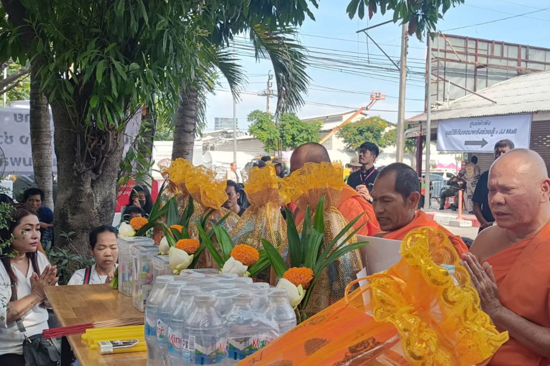 Relatives of missing Khmer workers in collapsed building offer alms to monks