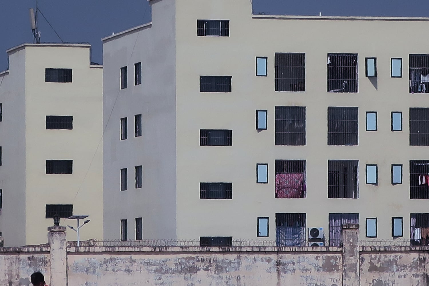 This image released by Amnesty International on June 26, 2025, as part of a report on scam centers in Cambodia shows “caged windows and barbed or razor wire on internal walls of a scamming compound.”