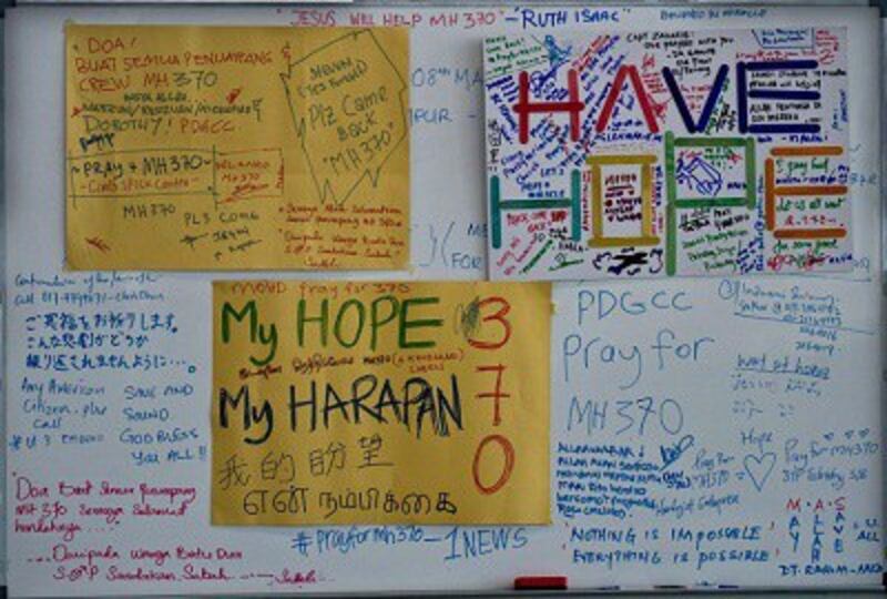 A board displays messages for the passengers of the missing Malaysia Airlines flight MH370 at Kuala Lumpur International Airport in Sepang, Malaysia on March 11, 2014. Photo credit: AFP.