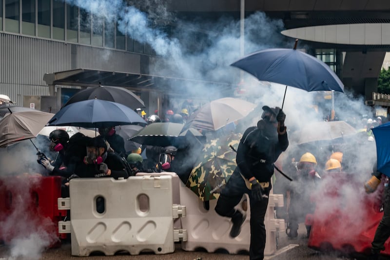 Protesters throw tear gas canisters back at police during an anti-government rally outside of Central Government Complex on August 31, 2019 in Hong Kong.