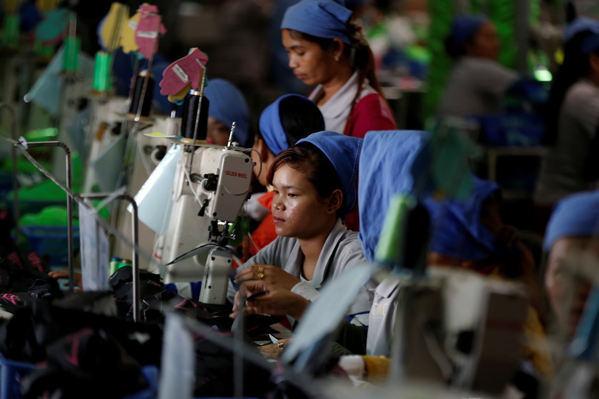 Women work on the production line at Complete Honour Footwear Industrial, a footwear factory owned by a Taiwan company, in Kampong Speu, Cambodia, July 4, 2018.
