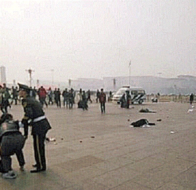 Tourists injured in the crash lie on the ground in Tiananmen Square while others flee the area, Oct. 28, 2013. Photo courtesy of a petitioner.