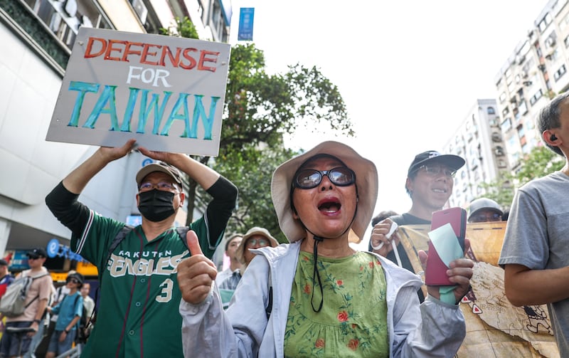 Protestors during a rally to oppose a scaled-down defense budget passed by the legislature in Taipei on May 23, 2026.