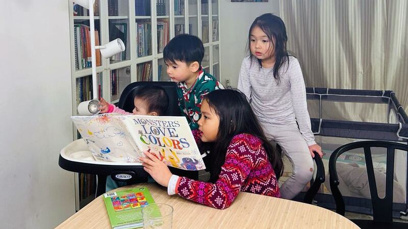 قاسىم ئابدۇرېھىمنىڭ بالىلىرى ئۆيدە كىتاب ئوقۇۋاتقان كۆرۈنۈش. 2024-يىلى، فېۋرال، ۋىرجىنىيە