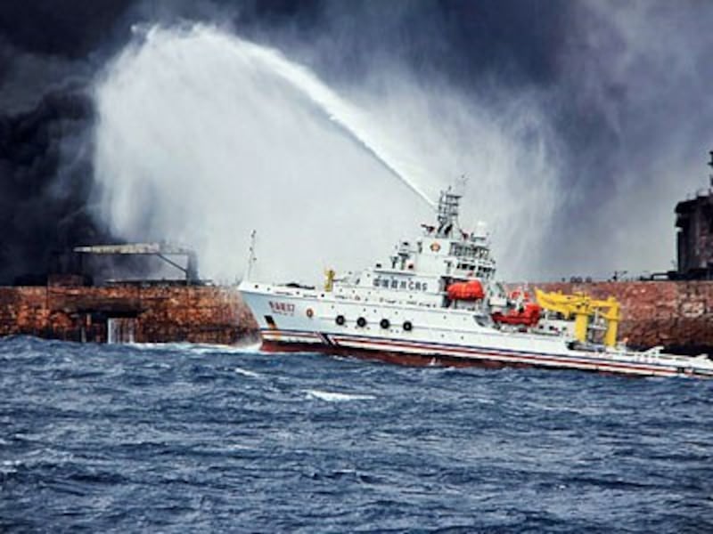 A Chinese firefighting vessel sprays foam on the burning oil tanker Sanchi at sea off the coast of eastern China, Jan. 12, 2018.