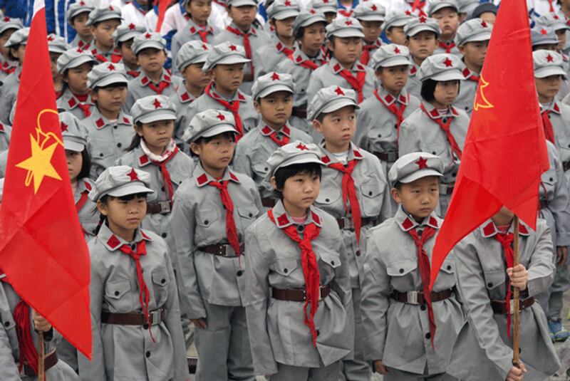 Primary school students wearing Red Army uniforms visit the Martyrs Cemetery in Yecheng, northwestern China's Xinjiang Uyghur Autonomous Region, ahead of the Qingming grave-tending festival, April 4, 2015. (Reuters)