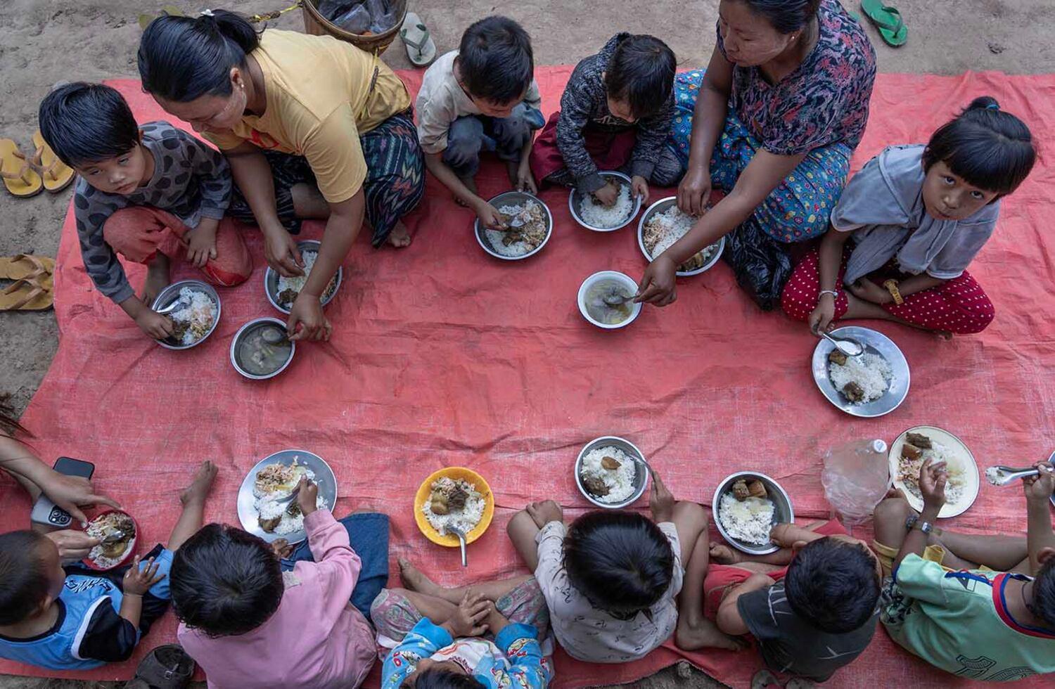 Internally displaced people have a meal in Yay Gu Taung IDP camp in Demoso, Myanmar, Nov. 3, 2024.