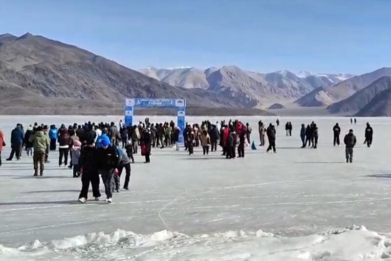 Participants in the Pangong Frozen Lake Marathon gather near the finish line on Pangong Tso lake, Tibet-India border, Feb. 25, 2025