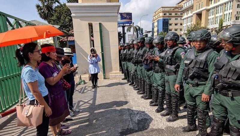 Cambodian police prevent women celebrating International Women's Day from leaving Olympic Stadium in Phnom Penh, March 8, 2019.