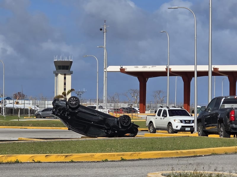 In a file photo, a vehicle lies upside down at Saipan International Airport after Super Typhoon Sinlaku struck the Northern Mariana Islands in mid‑April 2026.